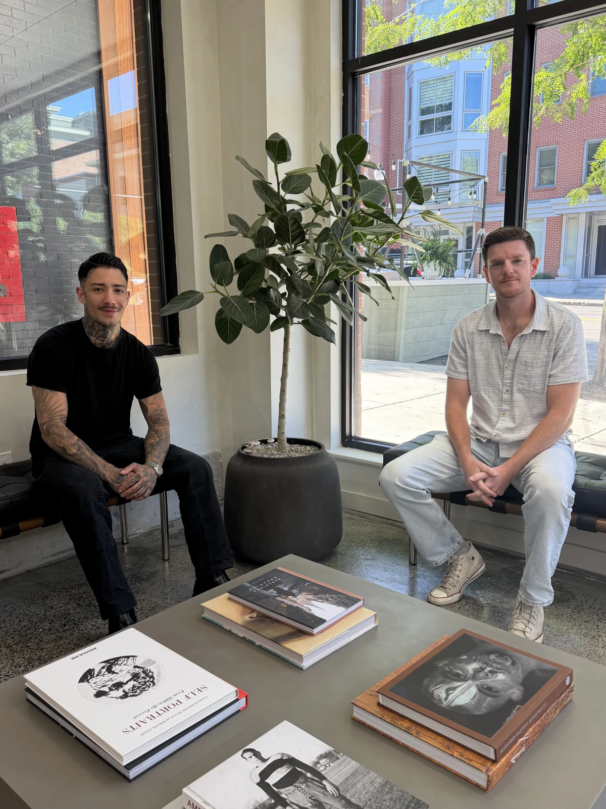 Andrew Brancato on the left and Josh Jackson on the right, sitting together inside the shop